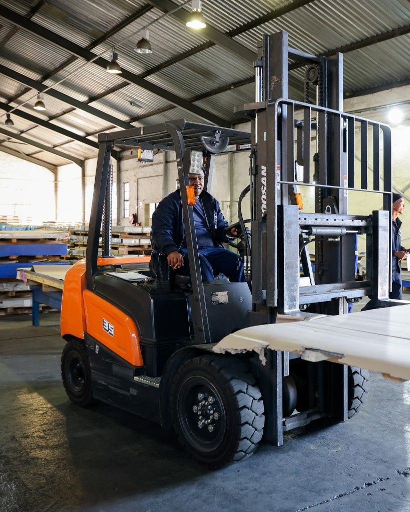 Berrick Trading warehouse — forklift moving stainless steel stock